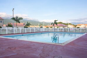 Relax by the pool surrounded by a picturesque mountain view.