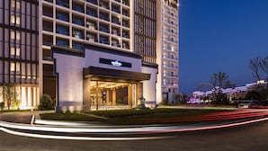 A modern hotel with a prominent entrance, multiple floors, and a well-lit facade. - Novotel Hefei Sunac (Hefei)