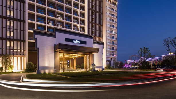 A modern hotel with a prominent entrance, multiple floors, and a well-lit facade. - Novotel Hefei Sunac (Hefei)