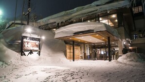 A hotel entrance with snow-covered surroundings and a visible signboard. - Takamiya Hotel Jurin (Yamagata)