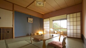 A traditional Japanese room with tatami flooring, a low wooden table, and sliding shoji doors. - Takamiya Hotel Jurin (Yamagata)