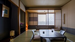 A traditional Japanese room with tatami flooring, a low table, and shoji screens. - Hotel Lucent Takamiya (Yamagata)