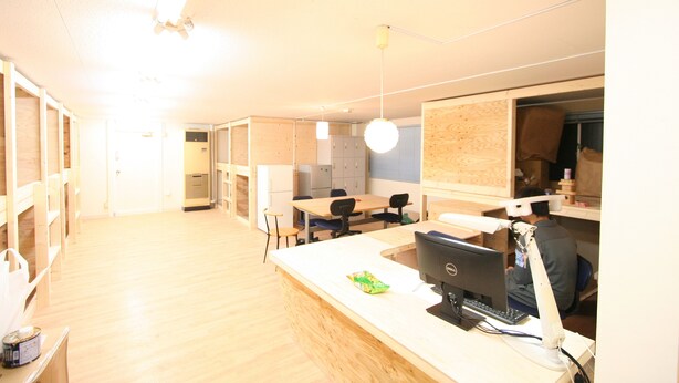A modern office space with desks, chairs, and a computer setup. - Edo Tokyo Hostel (Tokyo)