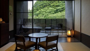 A modern room with a large sliding glass door leading to a balcony, wooden furniture, and a lantern.