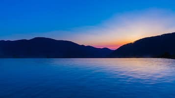 A serene lakeside view with mountains in the background.