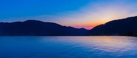 A serene lakeside view with mountains in the background.