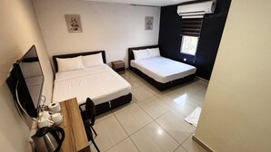 A hotel room with two beds, a desk with a chair, a small table with a kettle, and a window with blinds. - SOHO HOTEL (SEMENYIH) SDN. BHD. (Semenyih)