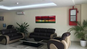 A living room with two sofas, a coffee table, and a painting on the wall. - SOHO HOTEL (SEMENYIH) SDN. BHD. (Semenyih)