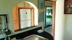 A kitchen with a stainless steel refrigerator, a sink, and a countertop. - Baan Laksee Pool Villa (Pattaya)