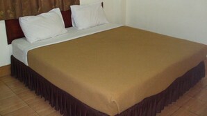 A standard hotel room with a single bed, white bedding, and a brown bedspread. - Souvanna Hotel 2 (Vientiane)
