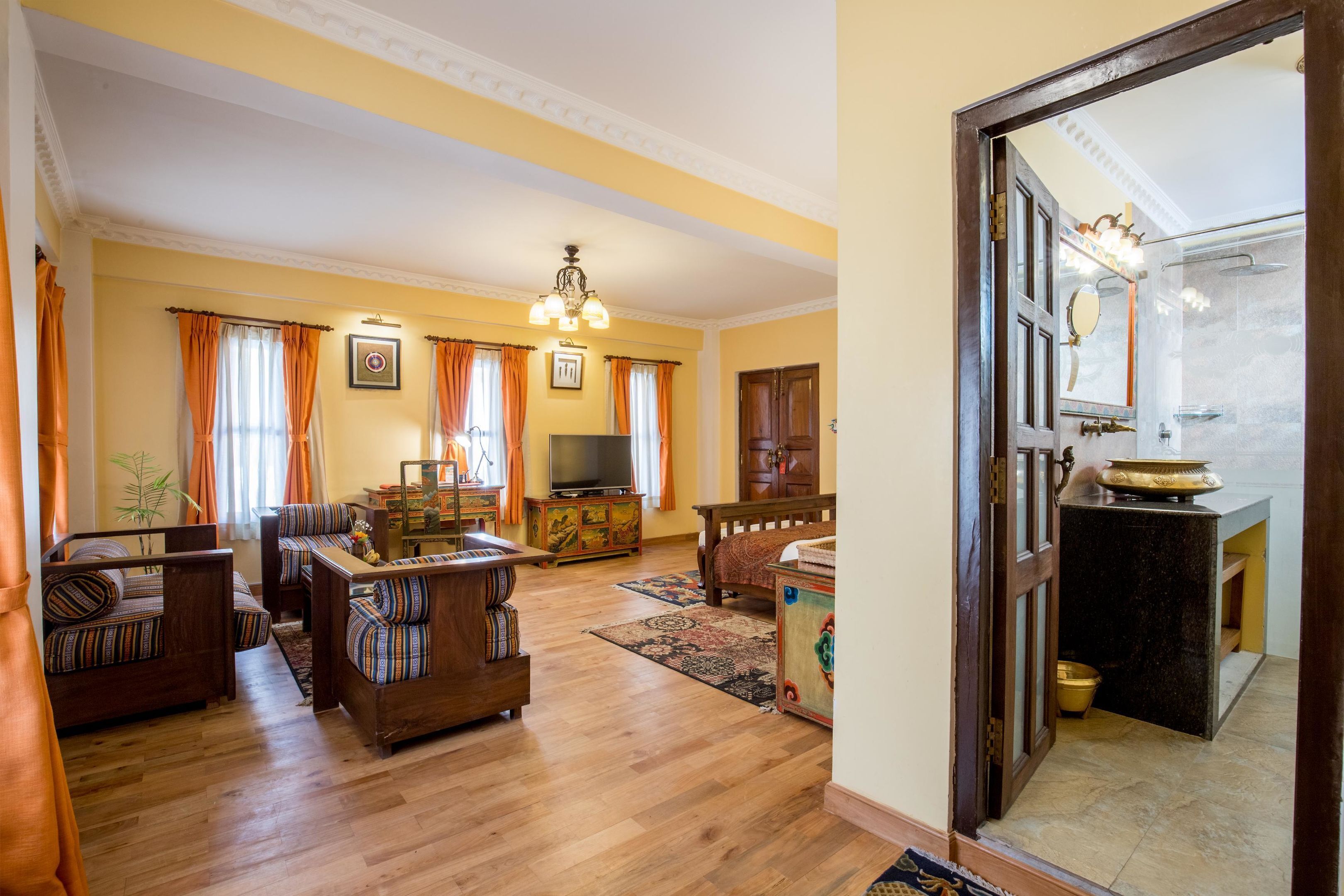 Amplia sala de estar con televisor, sofá y muebles de madera.
