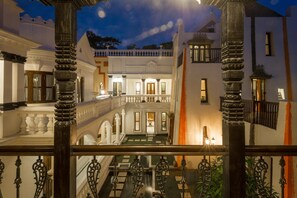 A grand hotel interior with ornate columns, a central courtyard, and a balcony with a railing. - Baber Mahal Vilas (Kathmandu)