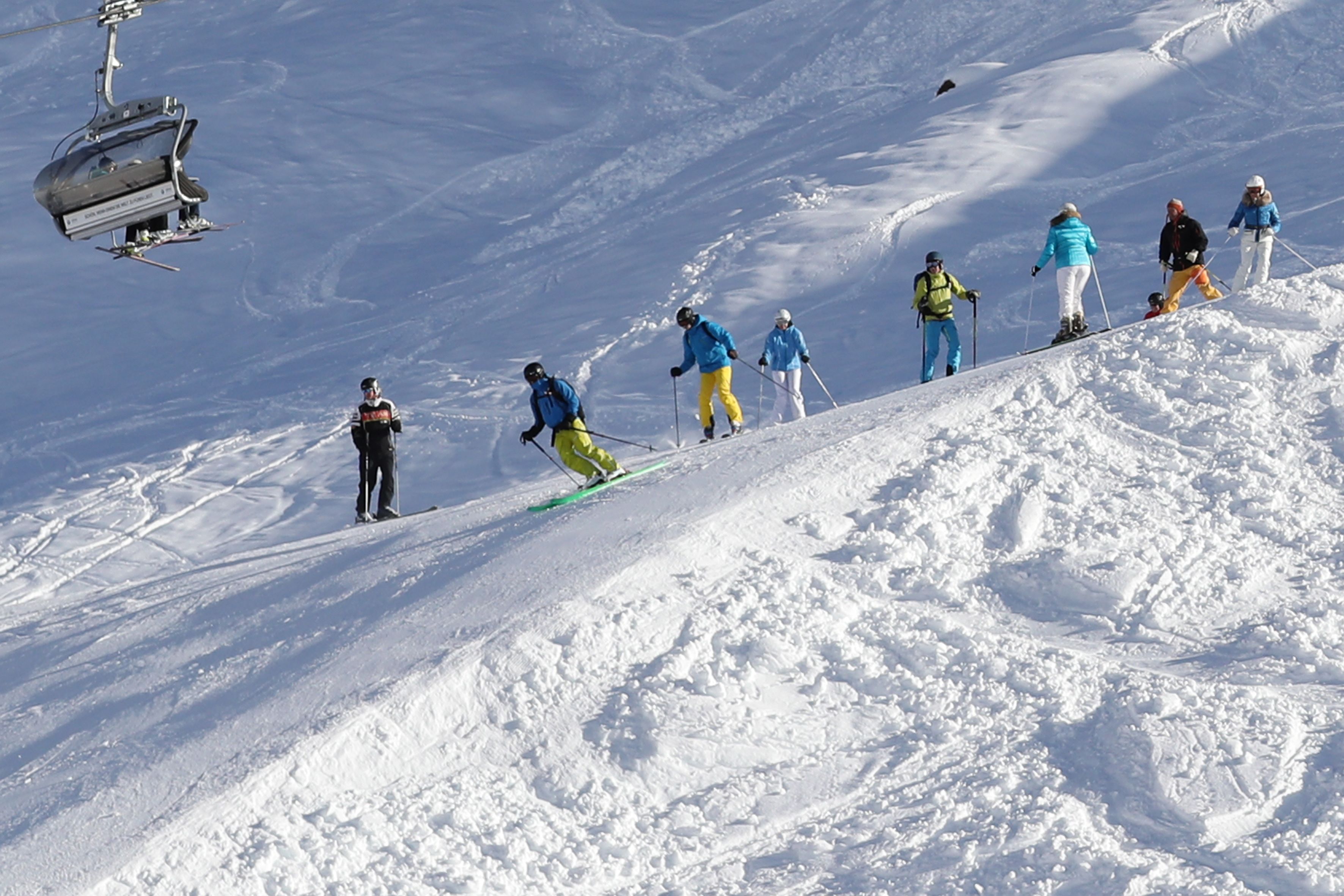 Eine Skipiste mit Skifahrern und einer Sesselbahn.