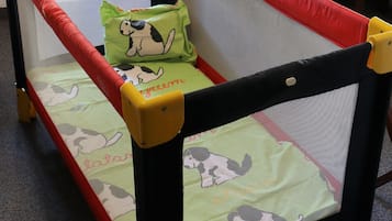 Children's play area features a safety gate, cushioned seating, and a table.