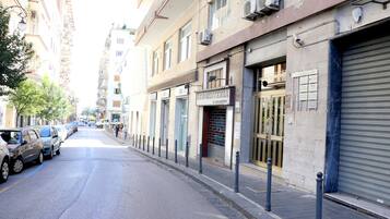 A street with parked cars and buildings.