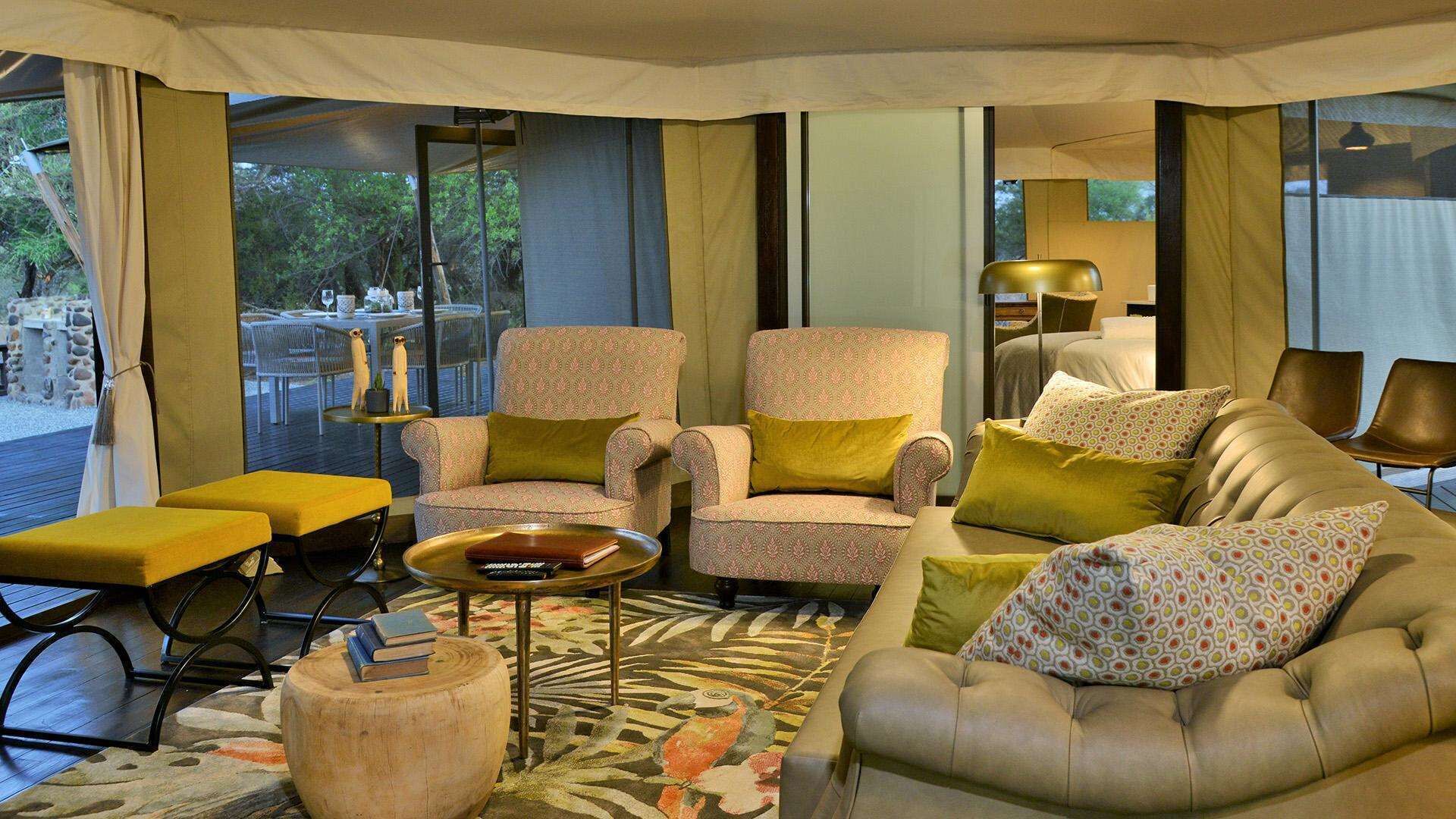A cozy indoor seating area with a sofa, armchairs, and a coffee table.