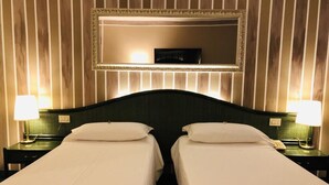 A hotel room with two beds, a large mirror above, and bedside lamps. - Green Park Bologna Residence (Granarolo dell'Emilia)