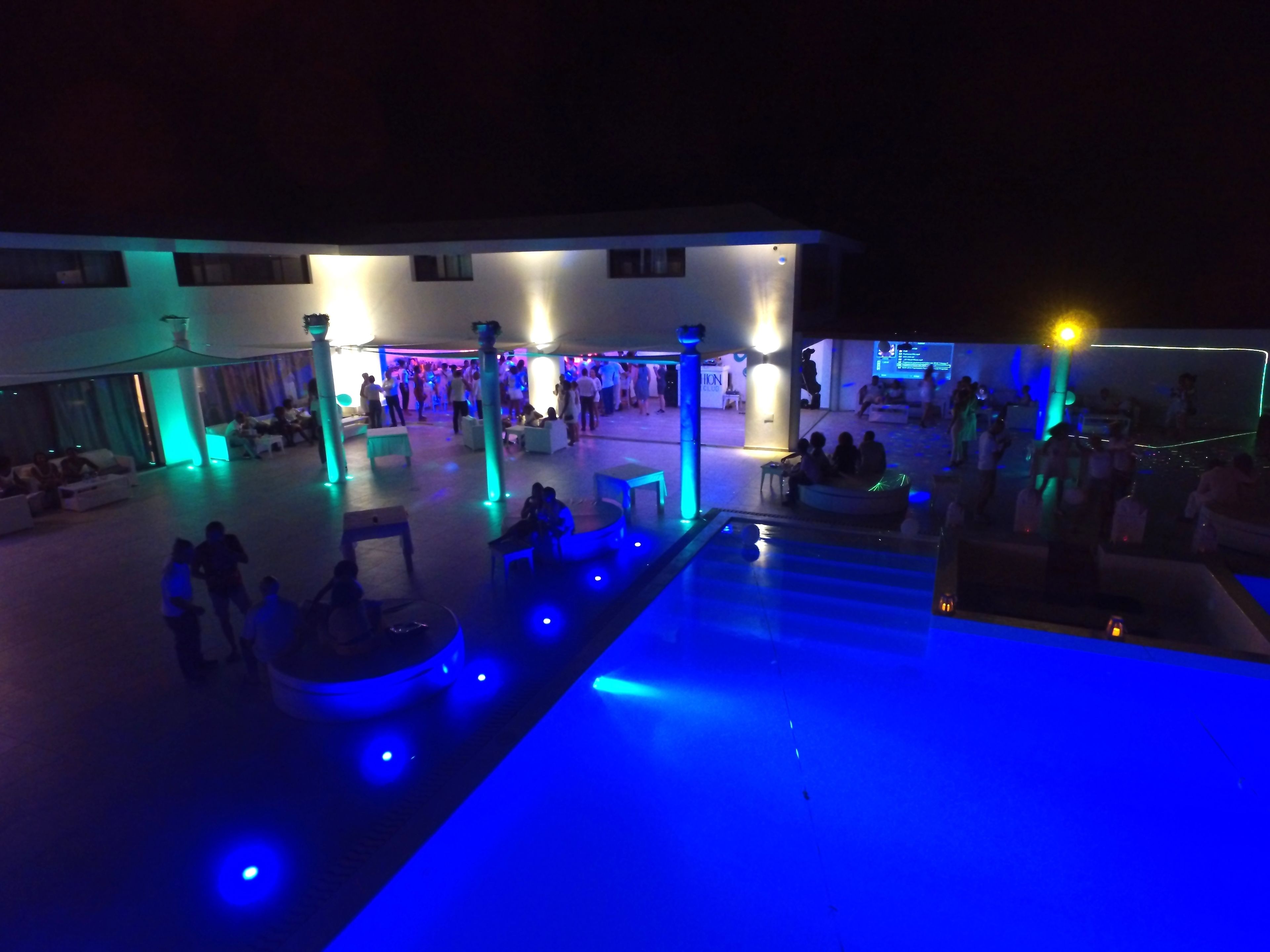 A spacious outdoor area with seating arrangements and a pool.
