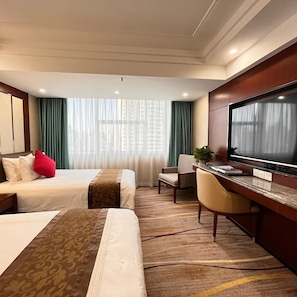 A hotel room with two beds, a desk, a television, and a window with curtains. - Skyline Plaza (Guangzhou)