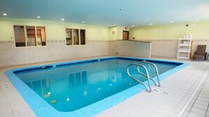 An indoor swimming pool with clear water, tiled floor, and a metal ladder. - Ramada By Wyndham Coeur D'alene (Coeur d'Alene)