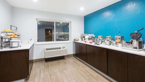 A kitchen with a window, a coffee station, and a fruit bowl. - Ramada By Wyndham Coeur D'alene (Coeur d'Alene)