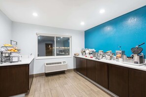 A kitchen with a window, a coffee station, and a fruit bowl. - Ramada By Wyndham Coeur D'alene (Coeur d'Alene)