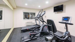 A gym with treadmills, an elliptical, and a stationary bike. - Ramada By Wyndham Coeur D'alene (Coeur d'Alene)