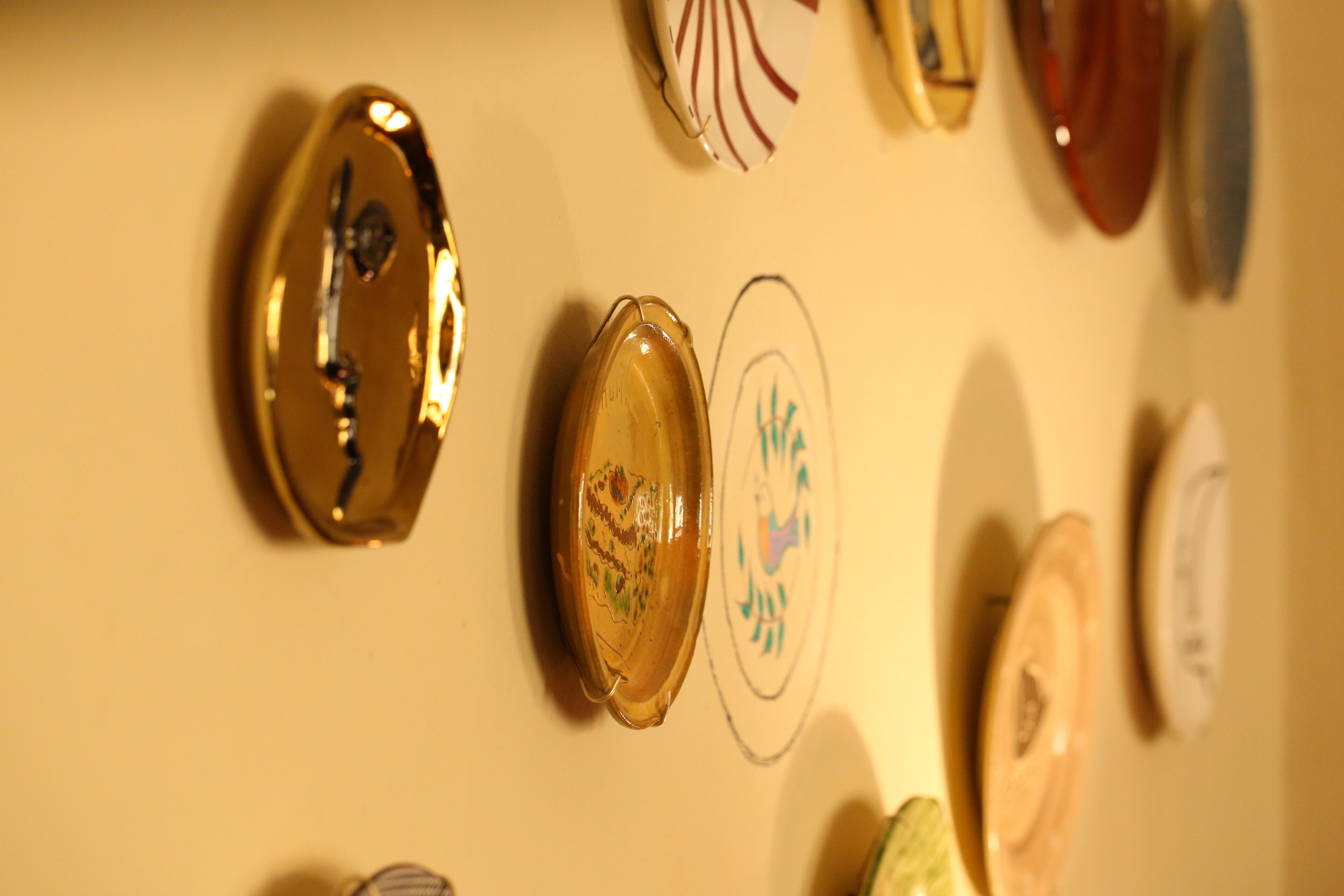 A wall with various decorative items, including a clock and a framed picture.