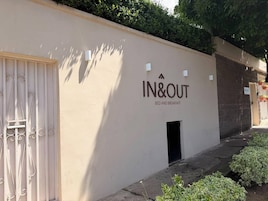 A building with a sign reading 'IN&OUT BED AND BREAKFAST' indicating a bed and breakfast service.