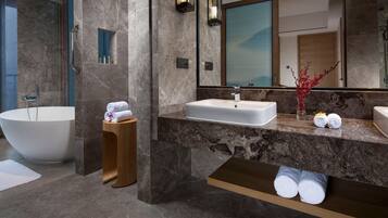A modern bathroom with a freestanding bathtub, a vanity with a sink, and a mirror.