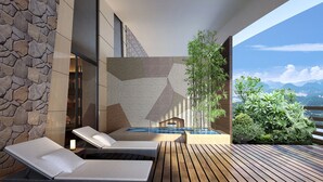 A modern outdoor lounge area with a stone wall, a pool, and a wooden deck. - Crowne Plaza Hangzhou Thousand Island Lake by IHG (Hangzhou)
