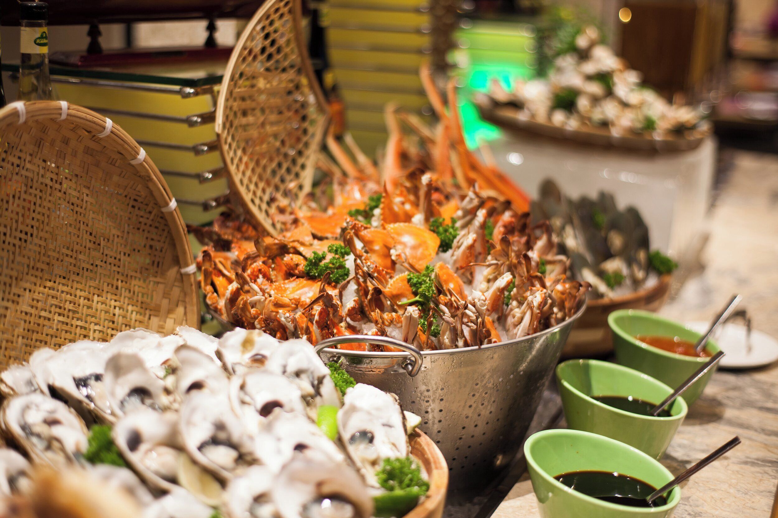 A seafood platter with various shellfish and a basket of oysters.