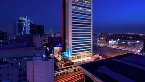A high-rise hotel with a modern design, featuring a prominent signage at the top. - Courtyard by Marriott Riyadh Olaya (Riyadh)