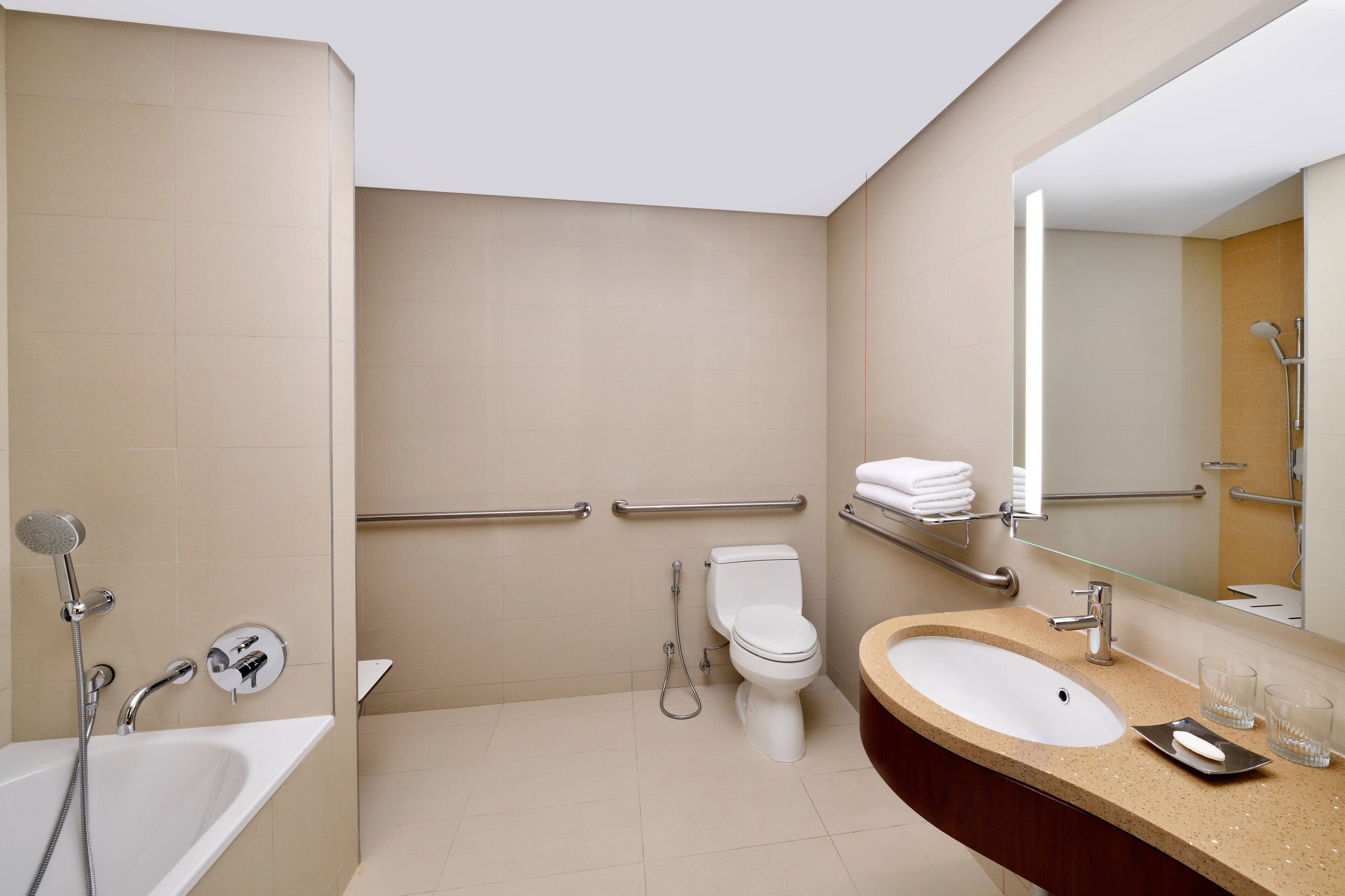 A modern bathroom with a bathtub, toilet, and sink.