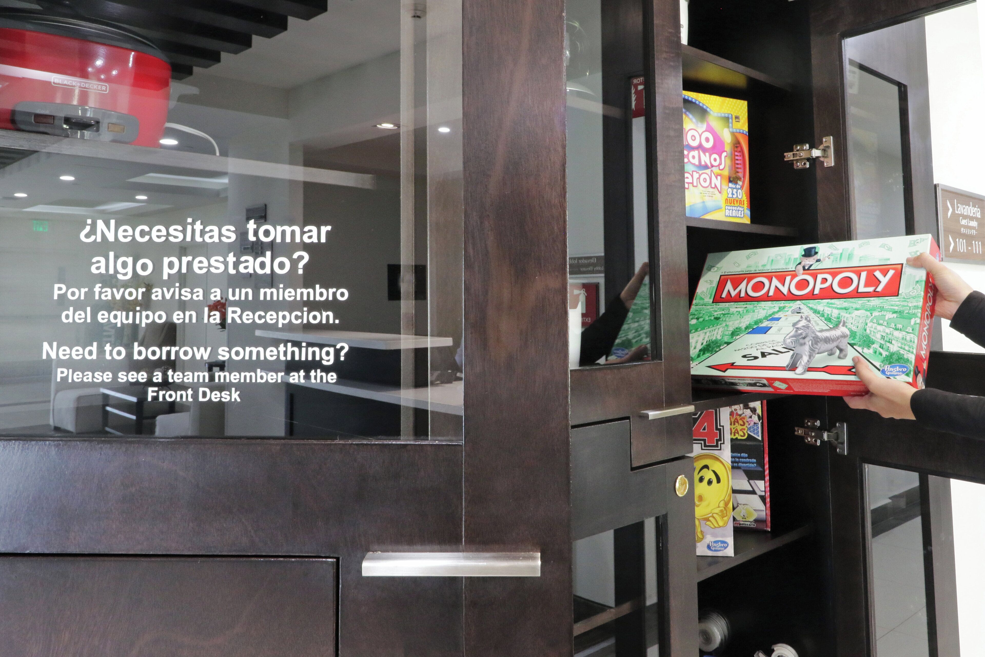 A glass door with a sign offering a loan service and a Monopoly board game on display.