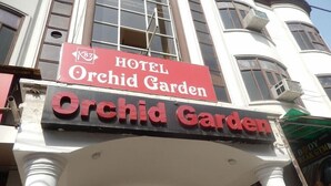 A hotel sign with the name 'Orchid Garden' and a smaller sign above it indicating 'HOTEL'. - Orchid Garden (New Delhi)