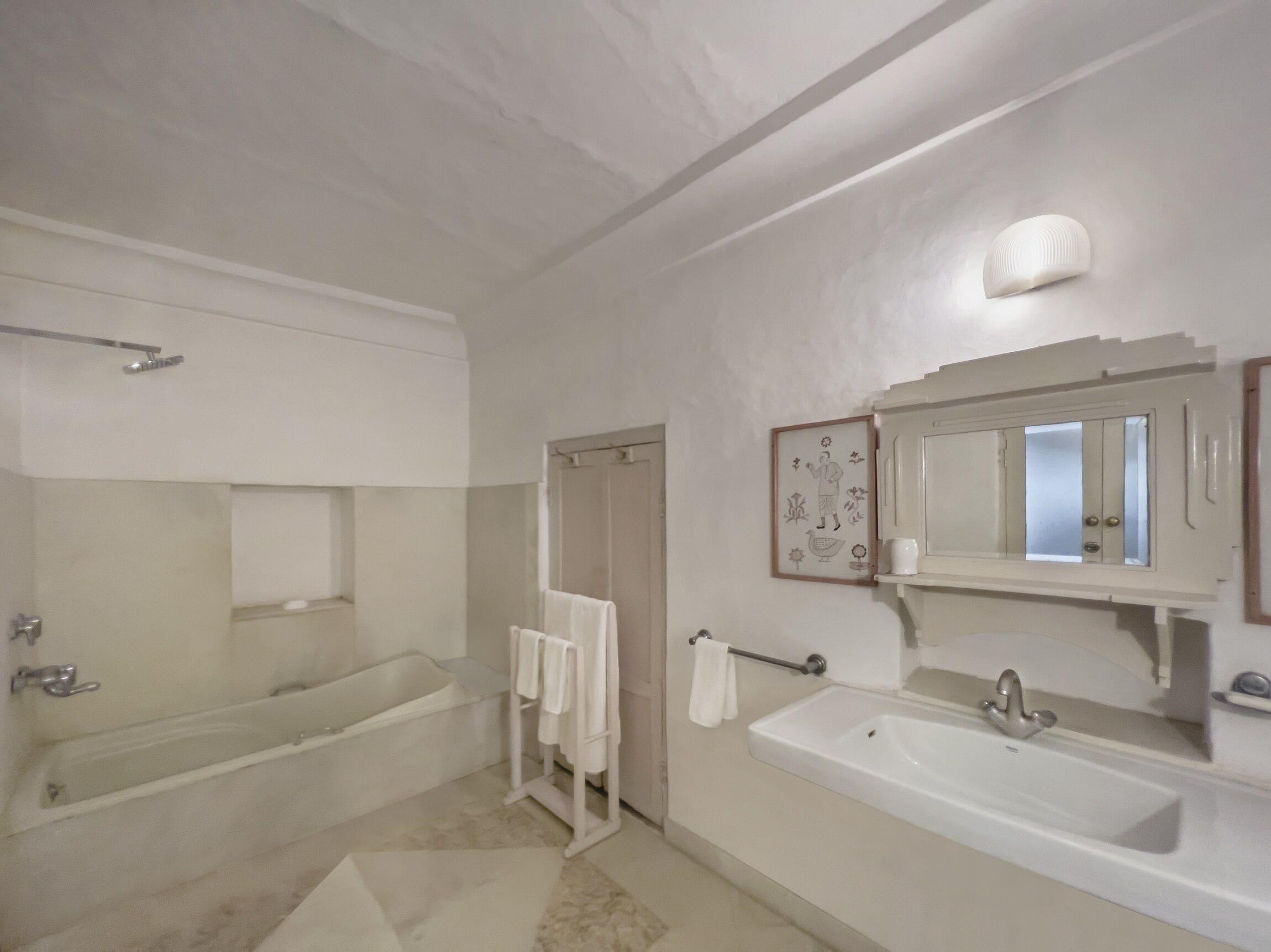 A bathroom with a bathtub, a sink, and a shower.