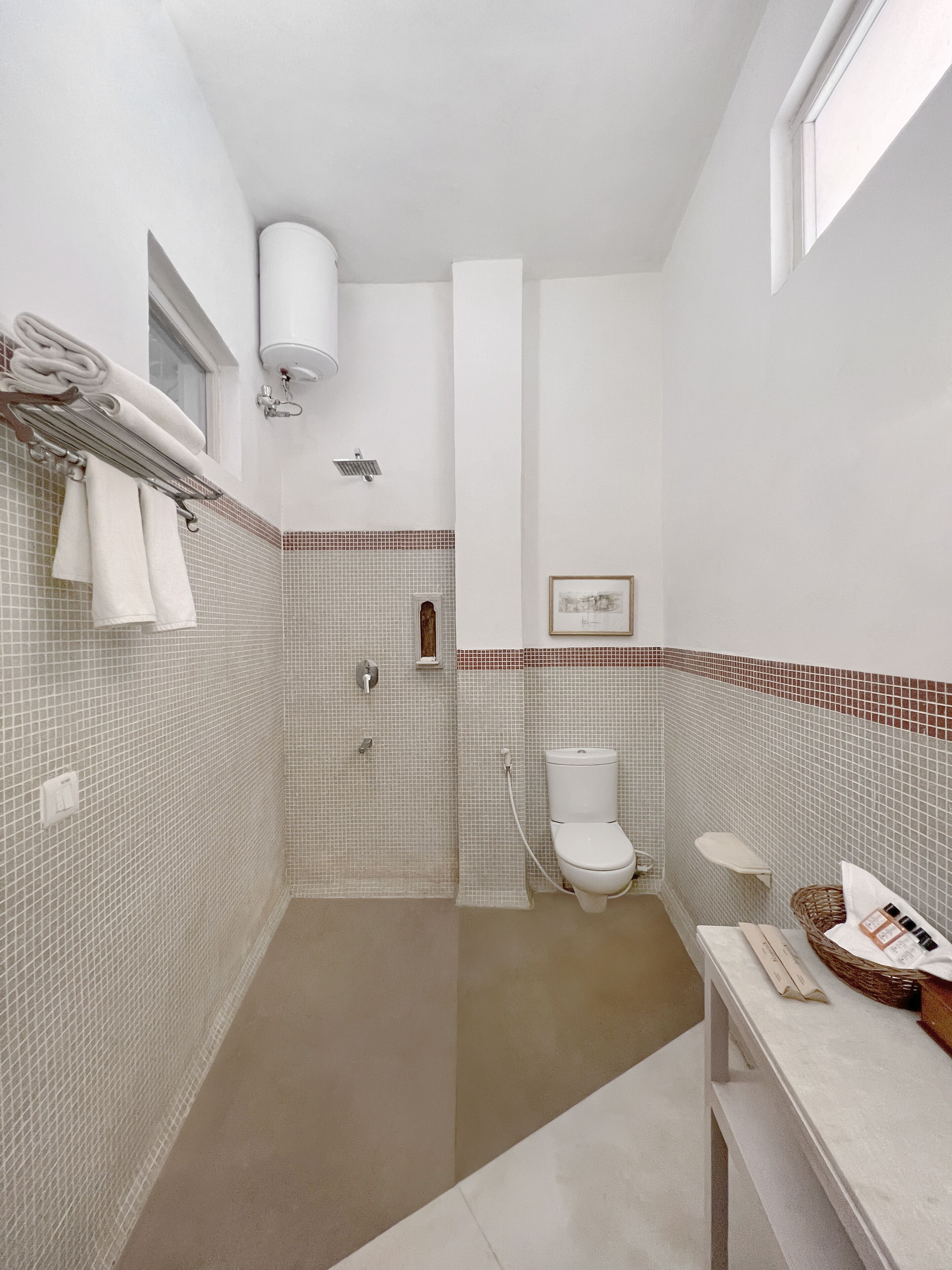 A bathroom with a shower, toilet, and sink.