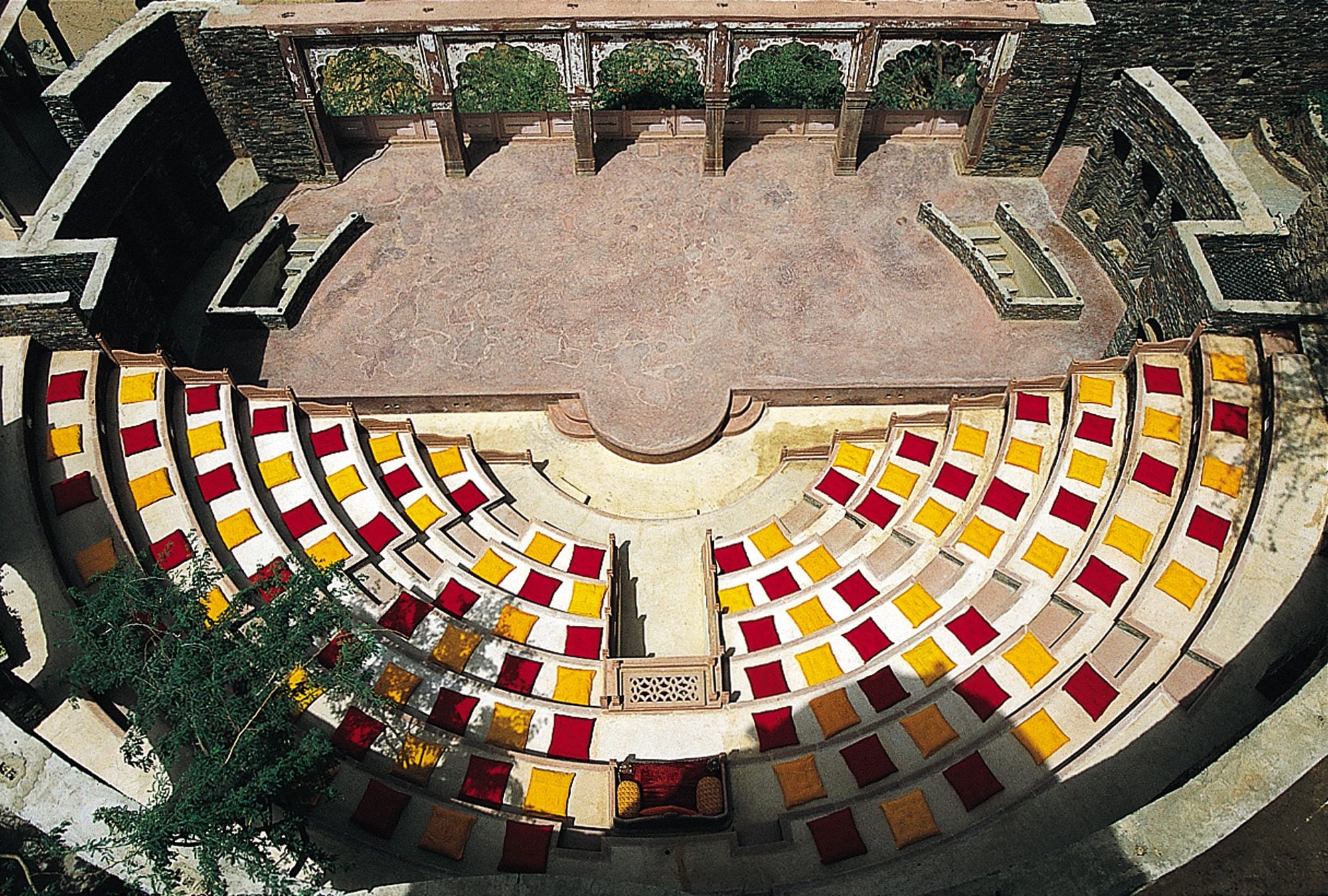 A circular amphitheater with tiered seating and a central stage.