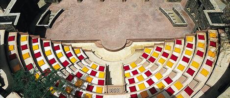 A circular amphitheater with tiered seating and a central stage.