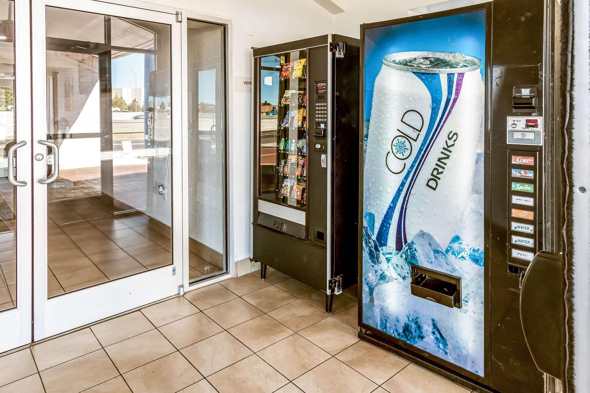 A cold drinks vending machine with a selection of beverages and a push button interface.