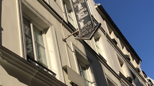 The exterior of the Castex Hotel with its classic architecture and signage.