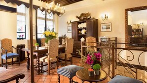 A cozy living room with a fireplace, comfortable seating, and a dining area.