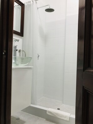 A small, enclosed shower area with a glass sink and a mirror above it. - Larq'a Park Rooms (Lima)