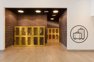 A hallway with a wall of letters and a wall with a suitcase icon.
