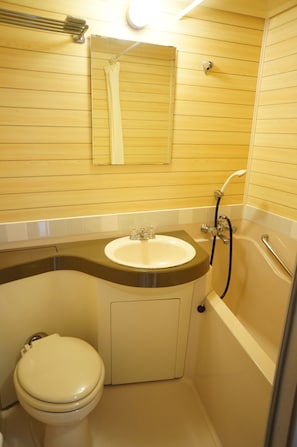 A small bathroom with a toilet, sink, and bathtub. - Villa Shirahama (Shimoda)