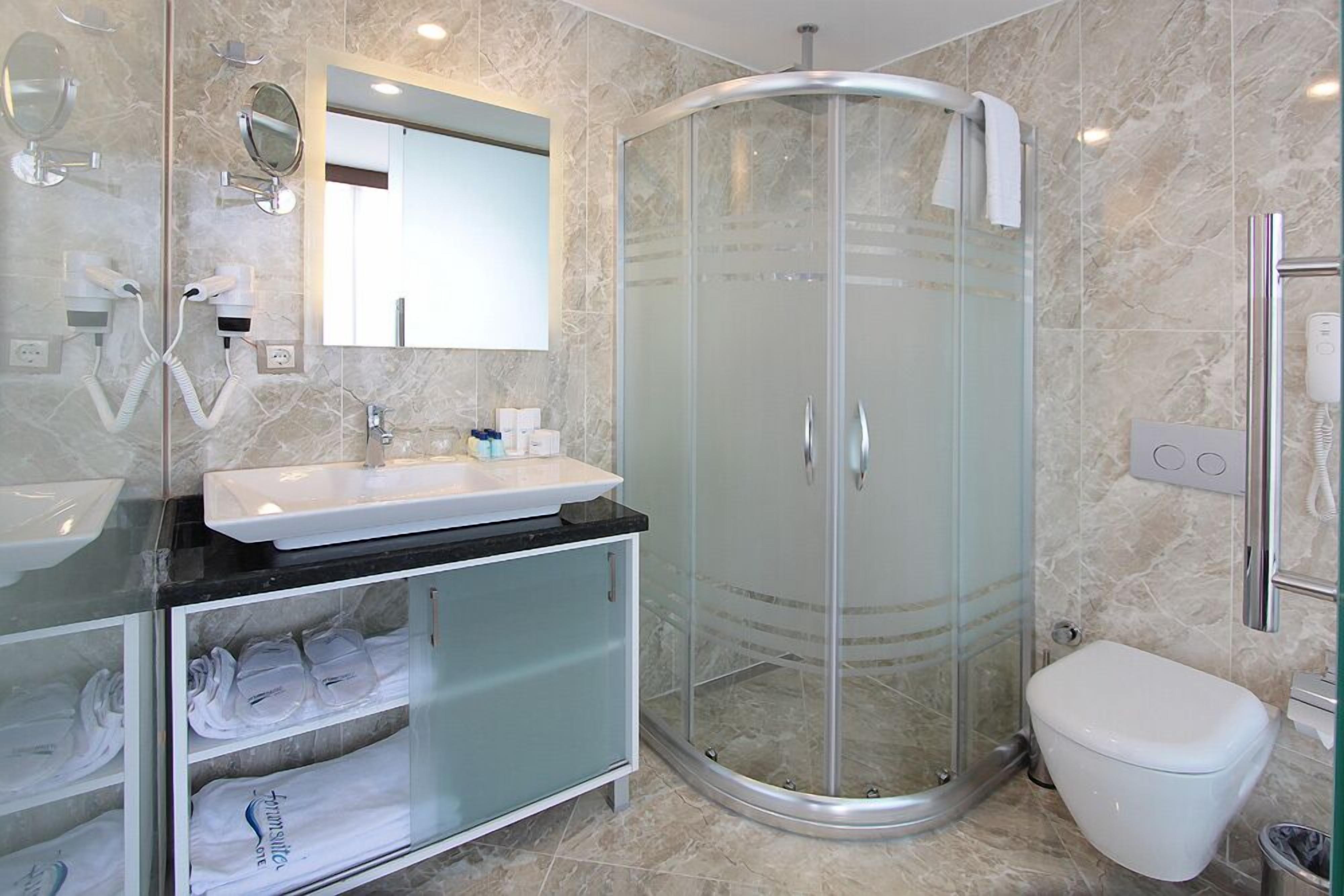 shower, hair dryer, slippers, towels