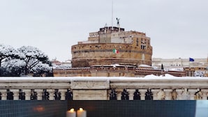 A snow-covered outdoor area with a historic building in the background. - Jacuzzi Rooms (Rome)