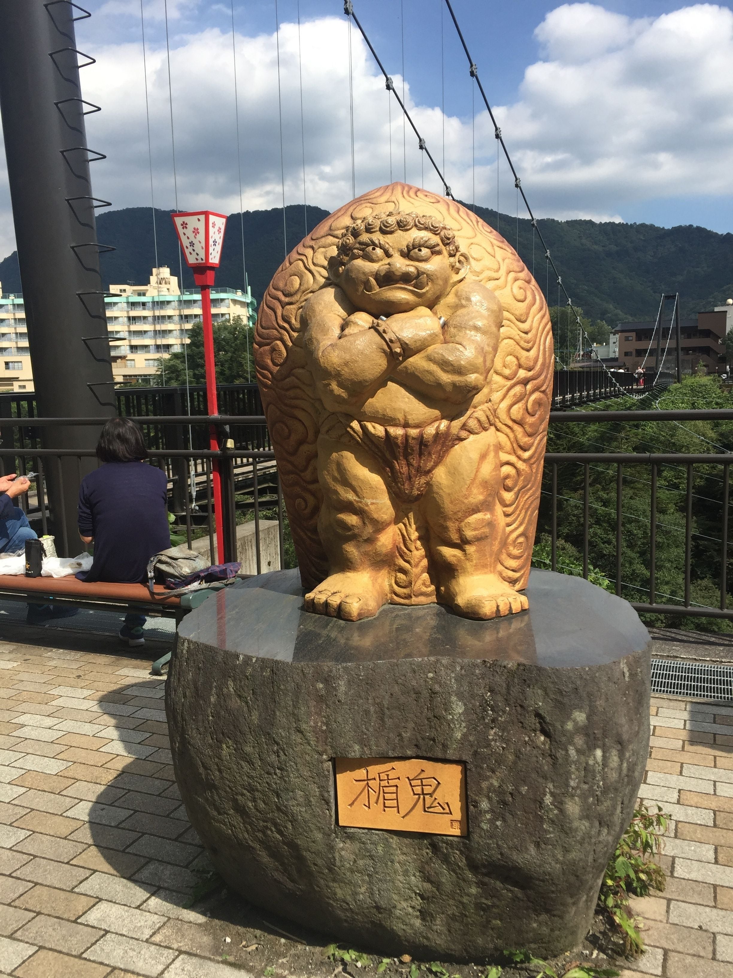 A large stone statue of a mythical creature with a label in front.