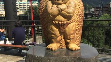A large stone statue of a mythical creature with a label in front.